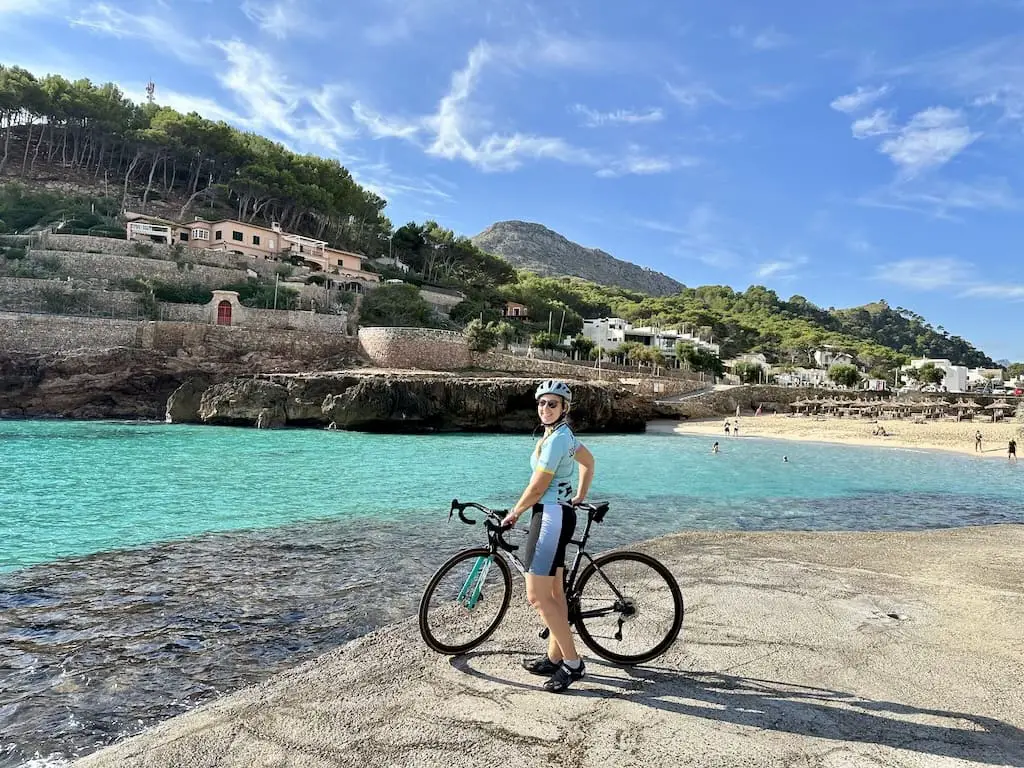 Frau mit Rennrad auf Mallorca, das Meer im Hintergrund
