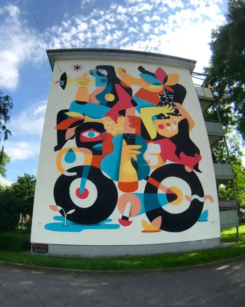 „Multicultural Balance“ von Ruben Sanchez (2019), Standort: Fassade eines Mehrfamilienhauses (GBG) in der Heustraße 13-17